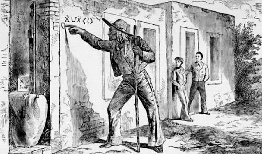 man-writing-wall-hobo-code-symbols-migrant